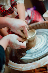 Child sculpts from clay pot. Workshop on modeling on the potter'