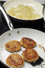Cooking Four Turkey Patties and Onions