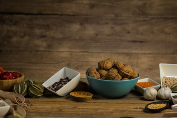 Bowls and spoons of various legumes on wooden table