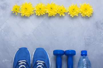 Summer flatlay composition with sport equipment and flowers