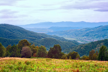 Mountain view, hiking through the mountains, panorama. Summer hiking trip. Sky, clouds and nature in the highlands, hiking trails.