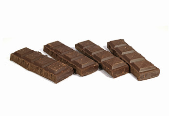 Lined Up Chocolate Bar Pieces Isolated on White Background