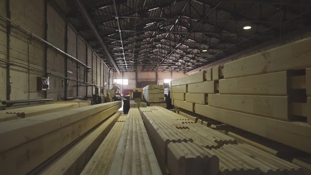 LVL. Engineered stress-rated product created by bonding together individual pieces of lumber. Large hangar with the production line for wood. Wood Factory: the production of laminated veneer lumber.