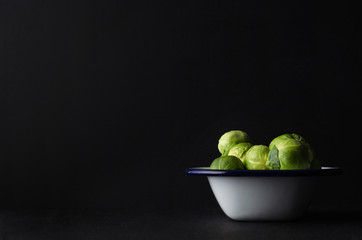 Brussel Sprouts Filling Enamal Baking Tin on Black Background