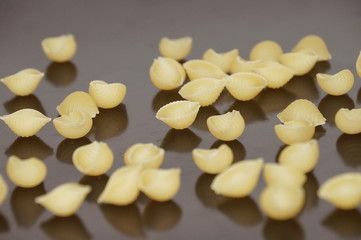 Macaroni scattered and isolated on a black background