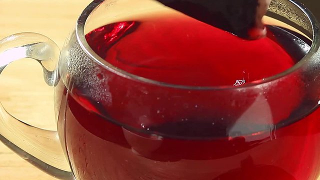 tea bag is lowered into the cup