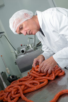 Butcher making sausages