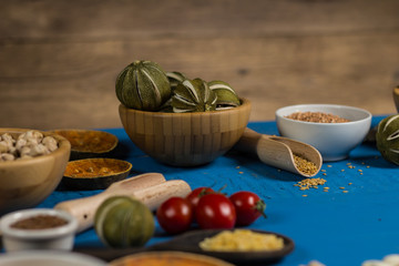 Bowls and spoons of various legumes on wooden table