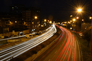 Naklejka na ściany i meble Rays of lights, car lights on a road, at night