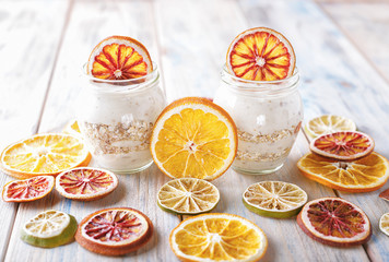 Delicious yoghurt with baked muesli and orange in a glass jar