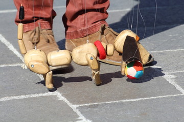 Traditional puppets made of wood. Puppet to form of dog moved by man.