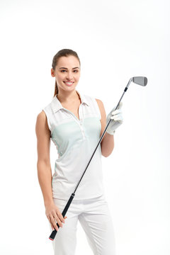 Pretty woman golfer posing with golf club on white background in studio