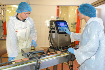 Naklejka premium Factory workers setting up production line