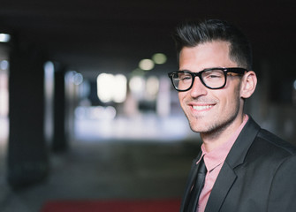 man close up with glasses smiling