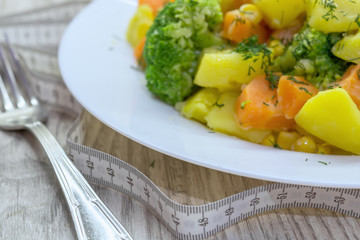 Healthy eating. Steamed Vegetables Potatoes, Carrots, Broccoli,Corn with Fresh Herbs