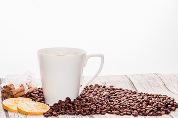 Coffee beans and white cup on a light background