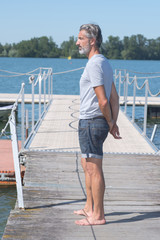 portrait of handsome man on pier looking calmly away