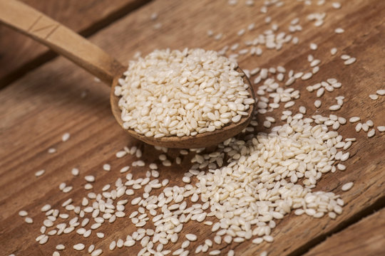 Fresh sesame seeds in a wooden spoon
