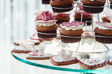 Cute candy bar with various candies and cakes. Wedding candybar