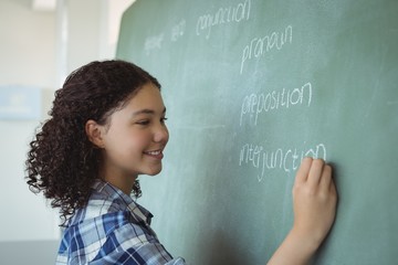 Schoolgirl pretending to be a teacher in classroom