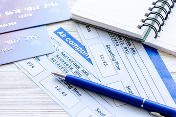 Buying airline tickets online with credit cards on table background