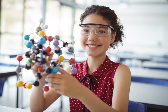 Portrait of schoolgirl experimenting molecule 