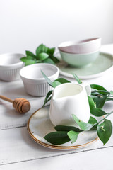 ceramic tableware with flowers on white background