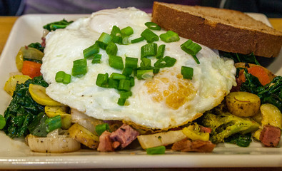 fried egg over potatoes and toast
