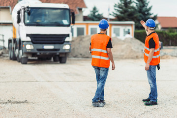 Construction workers navigating truck