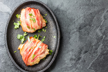 Baked bacon wrapped chicken on iron plate