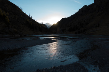 River and lake between the mountains at sunset