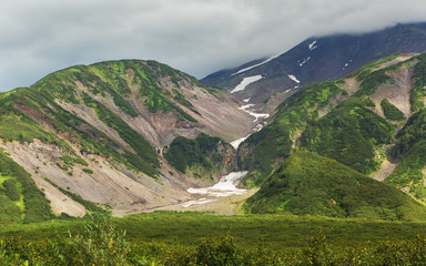Snow cover on mountains of Vilyuchinsky pass in the summer.
