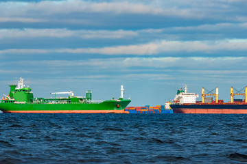 Obraz premium Cargo ships moored in still Baltic sea water