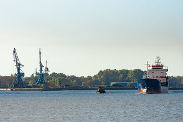 Blue cargo ship leaving the port of Riga