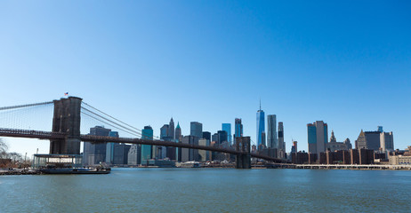 Fototapeta na wymiar View of Brooklyn Bridge and Manhattan skyline WTC Freedom Tower from Dumbo, Brooklyn. Brooklyn Bridge is one of the oldest suspension bridges in the USA