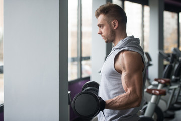 Obraz na płótnie Canvas Young Man Working Out Biceps