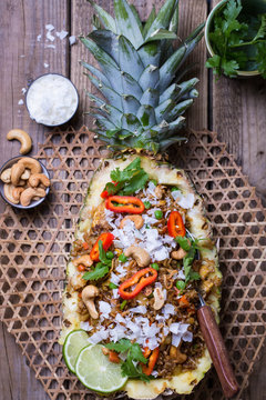 Pineapple fried rice served in a pineapple half. 
