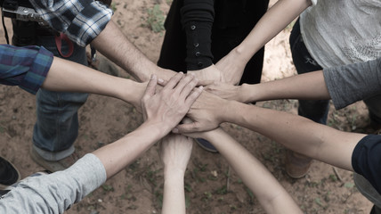 Group of people United Hands to built teamwork together with Spirit - teamwork concepts.