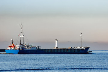 Blue cargo ship leaving Riga and entering Baltic sea
