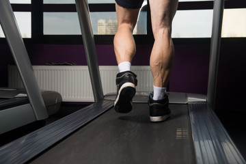 Fototapeta na wymiar Man Feet On Treadmill