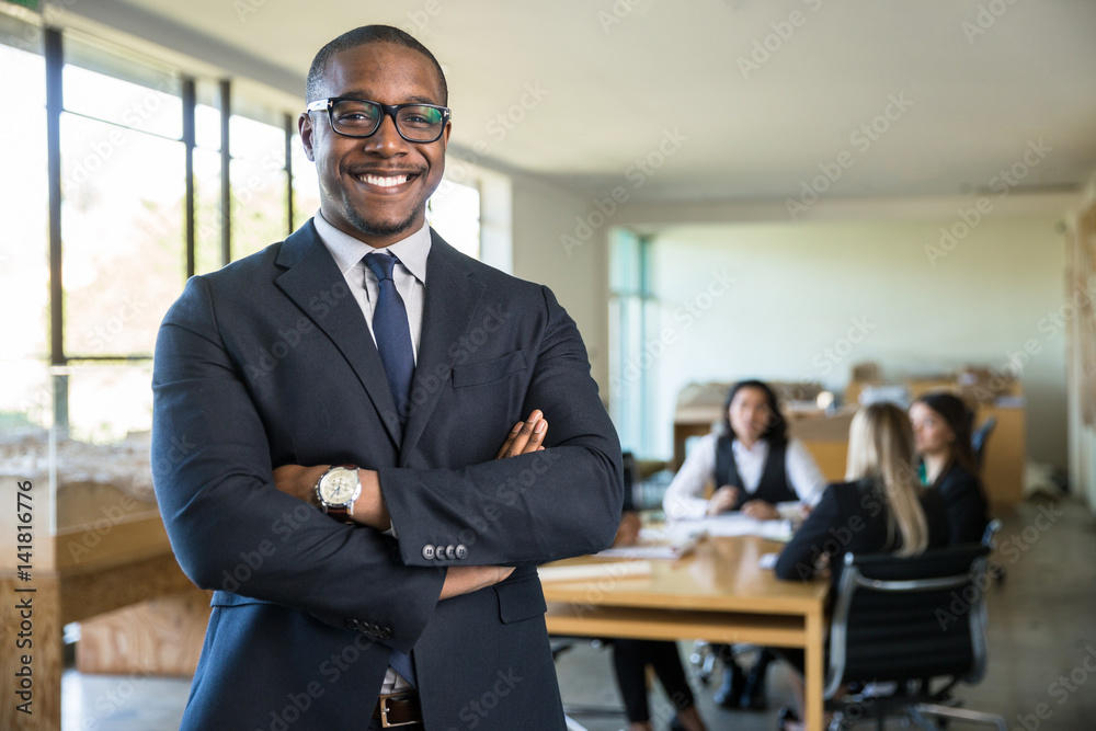 Wall mural smiling owner ceo at office work place portrait of worker in suit glasses and tie looking handsome