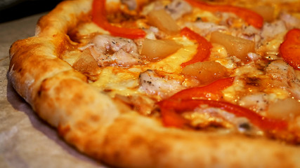 Italian pizza with meat, bacon, pepperoni and cheese close up