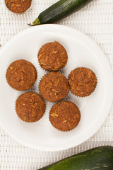 Plate of Organic Zucchini Muffins homemade on a white background vertical top view