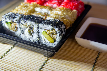 a plate of sushi pieces standing on a bamboo napkin 