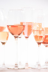 Many glasses of rose wine at wine tasting. Concept of rose wine and variety