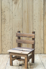 Fototapeta na wymiar mini model chair with wooden wall