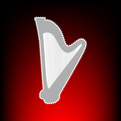 Obraz premium Musical instrument harp sign. Postage stamp or old photo style on red-black gradient background.