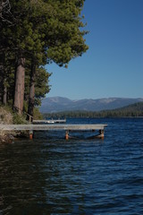 wooden pier on lake, mountain background