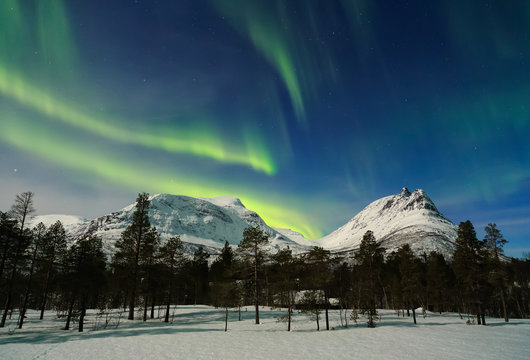 Aurora Borealis over mountains at night