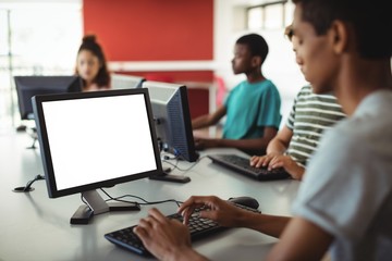 Students using computer in classroom